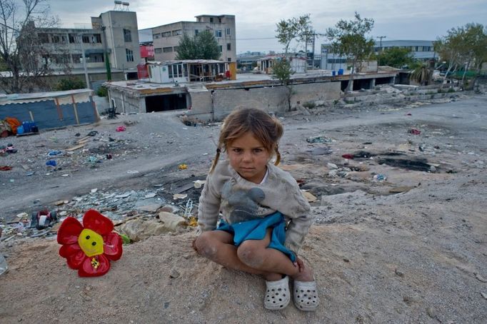 11 Titulek: Albanian gypsies face poverty in Greece Popis: October 22, 2011, Athens, Greece: October 22, 2011 - Athens, Greece: Gypsy girl plays with a plastic flower in the gypsy township. 800 Albanian gypsies live under extreme unhealthy conditions since 2000 in a township on an occupied, private property, only three km below Acropolis. Greek authorities are not able to transfer the gypsies to another legal land in order to gain access to clean water, sanitary and electricity- due to financial crisis. (Maro Kouri / polaris). In October 2013, an unidentified girl, called "Maria," was found in a Greek gypsy camp and could be related to missing child cases. Over 8,000 calls about the girl from all over the world including the U.S. and Canada have been received inquiring about the child. The blond girl, approximately age 4, was found in a Roma gypsy settlement in central Greece. DNA tests proved that she was not related to the 39-year-old man and 40-year-old woman who claimed to be her parents.