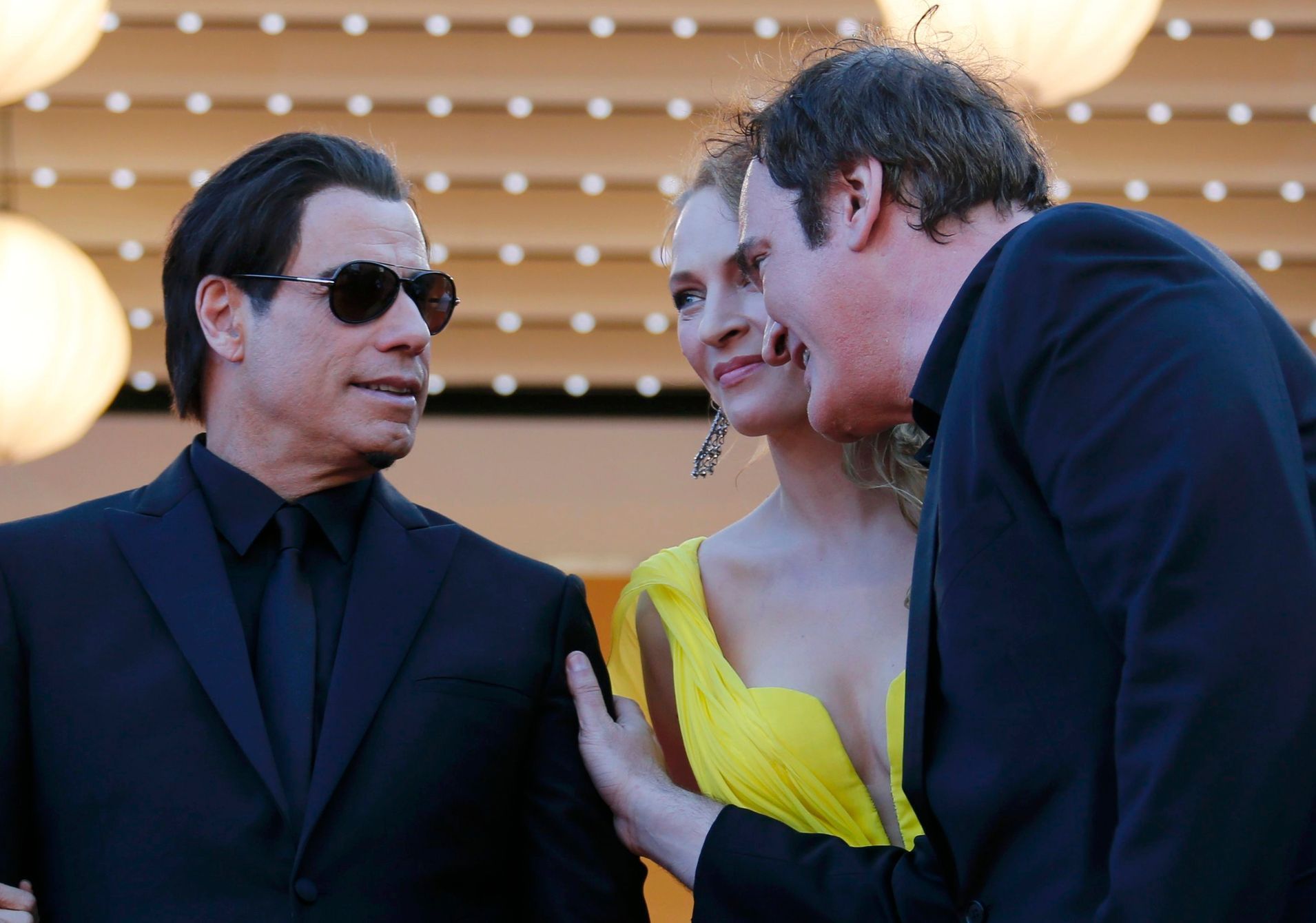 Director Quentin Tarantino, actress Uma Thurman and actor John Travolta pose on the red carpet they arrive for the screening of the film &quot;Sils Maria&quot; in competition at the 67th Cannes Film F