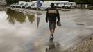 A man walks over the heating oil polluted car park of a car dealership after the floods of the Danube river subsided in Fischerdorf, a suburb of the eastern Bavarian city of Deggendorf June 10, 2013. Tens of thousands of people have been forced to leave their homes and there have been at least a dozen deaths as a result of floods that have hit Germany, Austria, Slovakia, Poland and the Czech Republic over the past week. REUTERS/Wolfgang Rattay (GERMANY - Tags: DISASTER TRANSPORT)