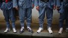 Mid-level government official dressed in red army uniforms wear sports shoes as they visit an old house where former Chinese leader Mao Zedong used to live, during a five-day training course at the communist party school called China Executive Leadership Academy of Jinggangshan, in Jiangxi province September 21, 2012. China Executive Leadership Academy was established in 2005 by the Central Committee of the Communist Party of China, after the 16th Communist Party Congress in 2002. By the end of August 2012, the academy has held 789 training classes for almost 40,000 people. During the course, trainees listen and sing revolutionary songs, visit old revolutionary sites and review historical communist materials. China has yet to announce the starting date for the 18th Communist Party Congress, China's biggest political meeting in a decade, which will see the transfer of power from President Hu Jintao and Premier Wen Jiabao to a new generation. REUTERS/Carlos Barria (CHINA - Tags: POLITICS SOCIETY) Published: Zář. 21, 2012, 3:43 odp.