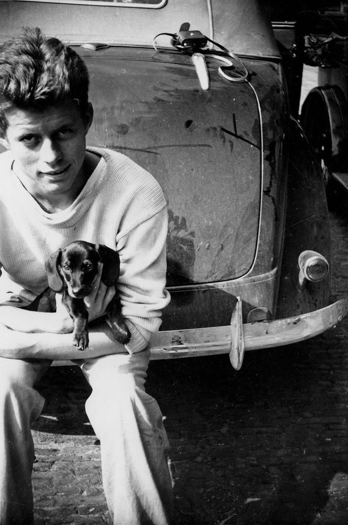 Former U.S. President John F. Kennedy holds the dog "Dunker" during his tour of Europe in the summer of 1937, in The Hague in this August 1937 handout image.