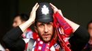 An Atletico Madrid fan wears a tradtional English policemen's helmet before the Champions League semi-final second leg soccer match between Chelsea and Atletico Madrid at