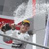 Mercedes Formula One driver Rosberg sprays champagne as he celebrates on podium after winningGerman F1 Grand Prix at Hockenheim
