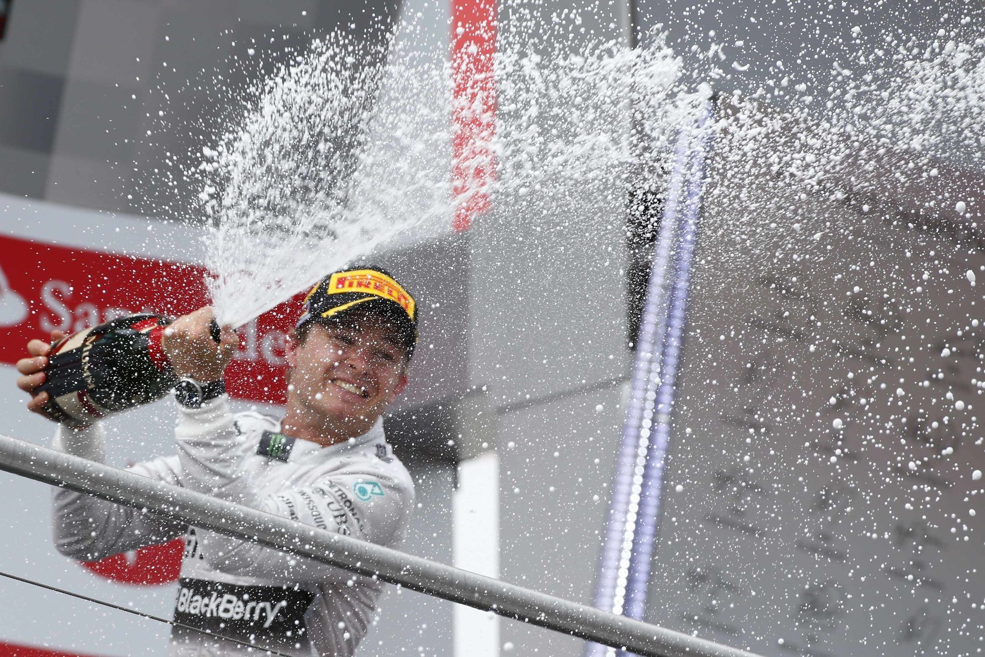 Mercedes Formula One driver Rosberg sprays champagne as he celebrates on podium after winningGerman F1 Grand Prix at Hockenheim