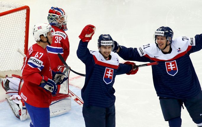 Slovakia's Tomas Tatar (C) celebrates his goal against Norway with team mate Radoslav Tybor (R) during the first period of their men's ice hockey World Championship group