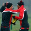 Manchester United's Kagawa hugs teammate Young during a training session at the club's Carrington training complex in Manchester