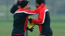 Manchester United's Kagawa hugs teammate Young during a training session at the club's Carrington training complex in Manchester