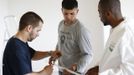 Unemployed Belgian Mohamed Sammar (C) is helped by instructor Michel Bokota (R) and a colleague as he works in a renovation site, part of the "Fit for a job" programme which includes a week-long work placement and aims to consolidate his previous work experience, in Brussels June 19, 2013. Sammar, 27, has been looking for a job in the construction sector for 2 years. "Fit for a job" is the initiative of former Belgian boxing champion Bea Diallo, whose goal was to restore the confidence of unemployed people and help them find a job through their participation in sports. Picture taken June 19, 2013. REUTERS/Francois Lenoir (BELGIUM - Tags: SPORT BOXING SOCIETY BUSINESS EMPLOYMENT) Published: Čec. 5, 2013, 4:29 odp.