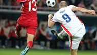 Striker Jan Koller shooting at goal, with Emre Güngör trying to block his attempt.