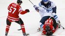 Finland's Petri Kontiola falls over Canada's Brayden Schenn (lower) during their men's ice hockey World Championship quarter-final game at Chizhovka Arena in Minsk May 22