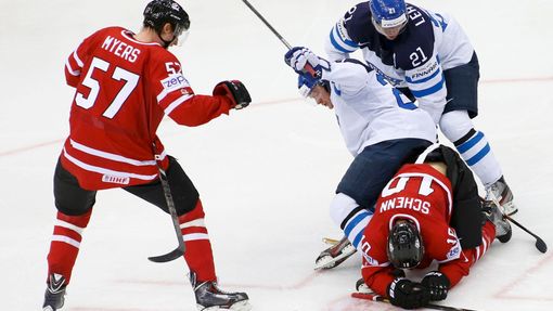 Finland's Petri Kontiola falls over Canada's Brayden Schenn (lower) during their men's ice hockey World Championship quarter-final game at Chizhovka Arena in Minsk May 22