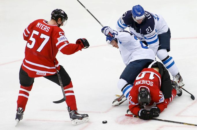 Finland's Petri Kontiola falls over Canada's Brayden Schenn (lower) during their men's ice hockey World Championship quarter-final game at Chizhovka Arena in Minsk May 22