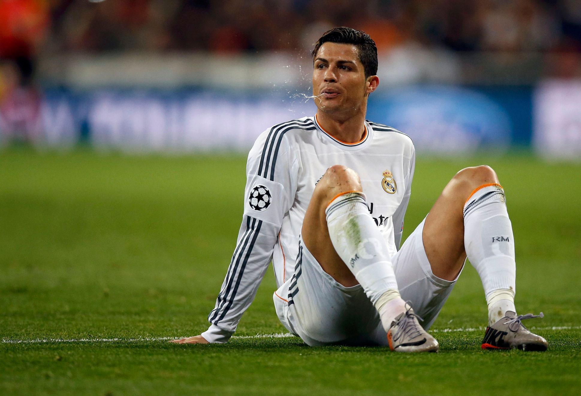 Real Madrid's Ronaldo spits out as he sits in the pitch during their Champions League quarter-final first leg soccer match against Borussia Dortmund in Madrid