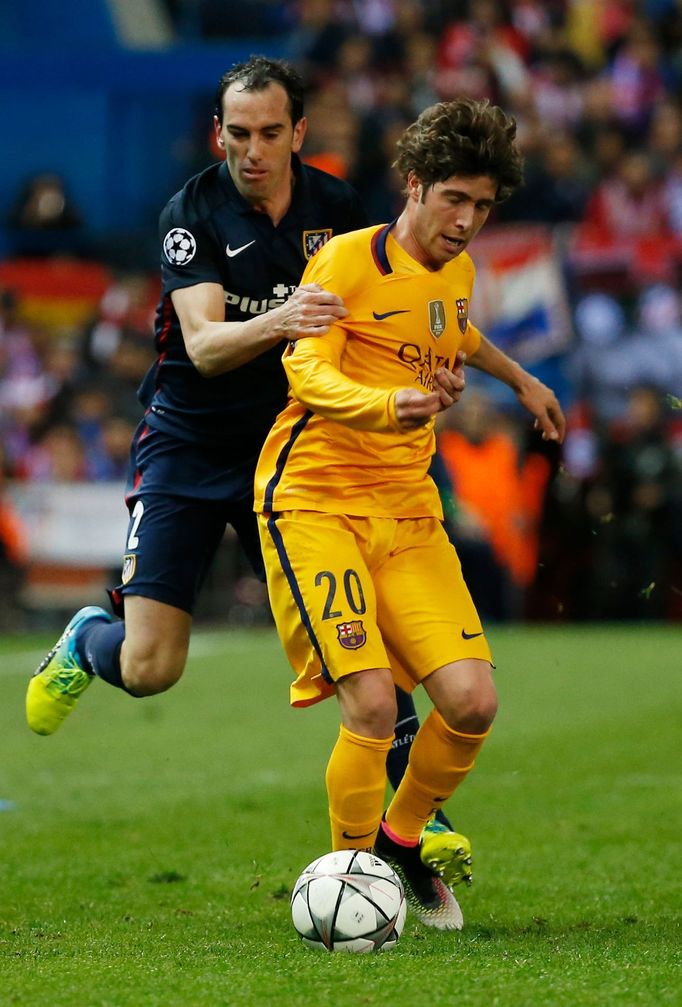 Barcelona's Sergi Roberto in action with Atletico's Diego Godin