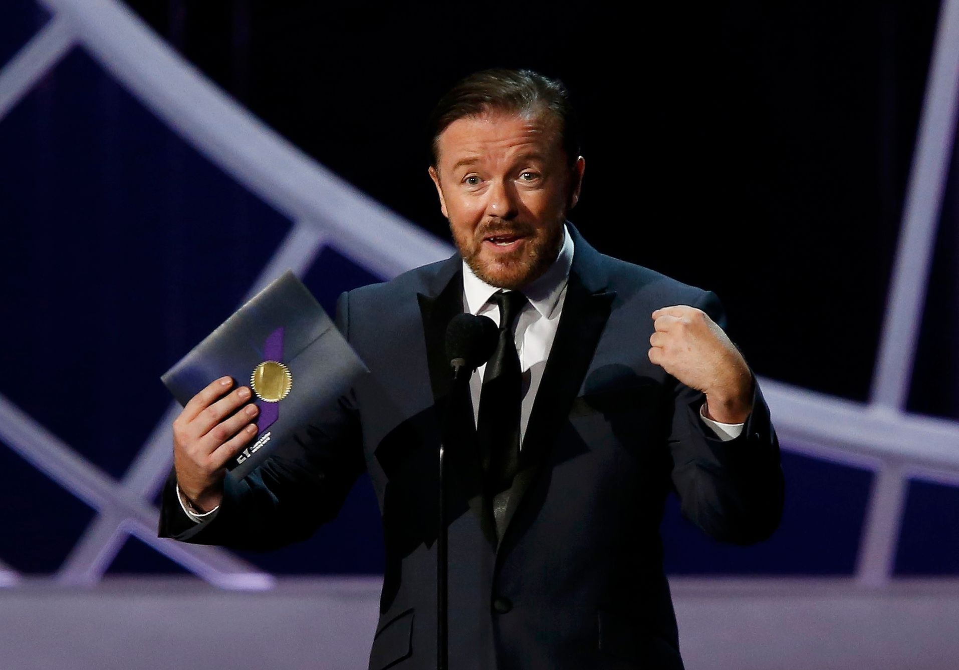 Ricky Gervais presents the award for Outstanding Writing For A Variety Series during the 66th Primetime Emmy Awards in Los Angeles