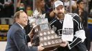 Los Angeles Kings' Justin Williams (R) is presented with the Conn Smythe trophy as the Most Valuable Player from NHL Commissioner Gary Bettman after Game 5 of their NHL S