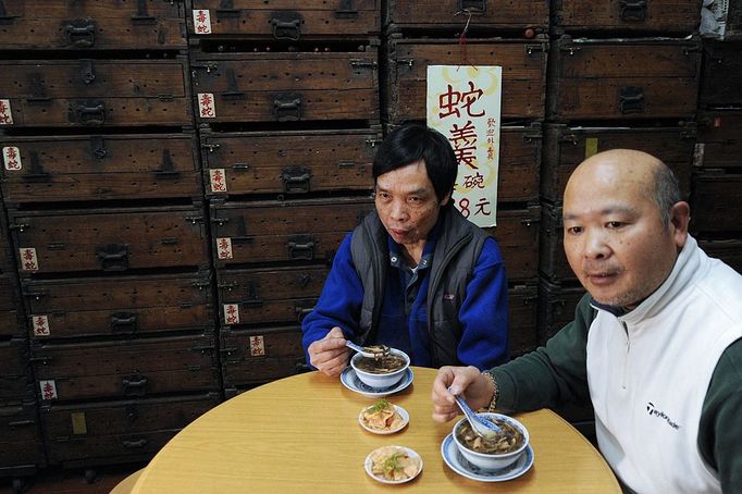 TO GO WITH Lifestyle-medicine-health,FEATURE by Joyce Woo This photo taken on January 31, 2011 shows diners having soup at the She Wong Lam snake soup shop in Hong Kong. Snake has been used in China for thousands of years to cure a host of ailments -- snake-fermented wine for arthritis, snake genitals for the kidneys and male sex drive, snake gall bladder for bronchitis.