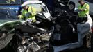 Police officers work amongst the wreckage of some of the 100 vehicles involved in multiple collisions, which took place in dense fog during the morning rush hour, on the Sheppey Bridge in Kent, east of London, September 5, 2013. Eight people were seriously injured and dozens hurt in the multiple crashes.