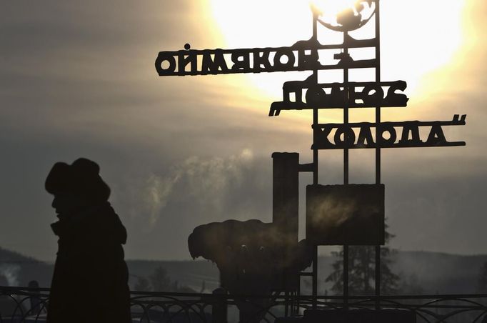 A man passes a sign saying "Oymyakon 'Pole of Cold'" on the site of a former meteorological station in the village of Oymyakon, in the Republic of Sakha, northeast Russia, January 26, 2013. The coldest temperatures in the northern hemisphere have been recorded in the Oymyakon valley, where according to the United Kingdom Met Office a temperature of -67.8 degrees Celsius (-90 degrees Fahrenheit) was registered in 1933 - the coldest on record in the northern hemisphere since the beginning of the 20th century. Yet despite the harsh climate, people live in the valley, and the area is equipped with schools, a post office, a bank, and even an airport runway (albeit open only in the summer). Picture taken January 26, 2013. REUTERS/Maxim Shemetov (RUSSIA - Tags: SOCIETY ENVIRONMENT SCIENCE TECHNOLOGY TPX IMAGES OF THE DAY) ATTENTION EDITORS: PICTURE 1 OF 27 FOR PACKAGE 'THE POLE OF COLD' SEARCH 'MAXIM COLD' FOR ALL IMAGES Published: Úno. 18, 2013, 11:25 dop.