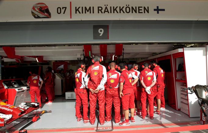 Ferrari engineers block the view of Ferrari Formula One driver Kimi Raikkonen of Finland as they stand around his car during the first practice session of the Bahrain F1