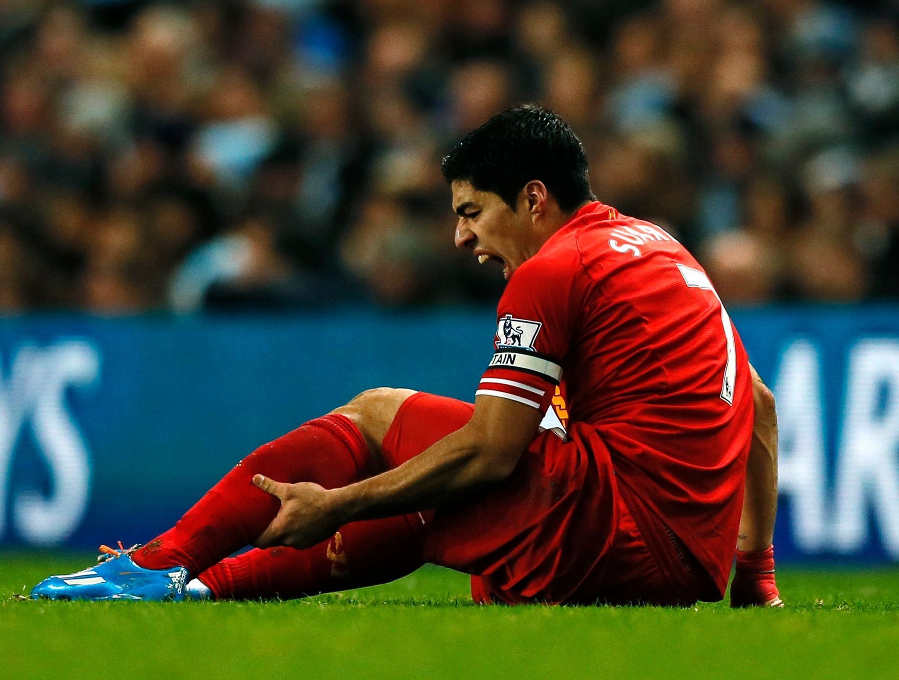 Liverpool's Suarez holds his leg during their English Premier League soccer match against Manchester City in Manchester