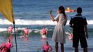 Catherine, Britain's Duchess of Cambridge, waves as she watches junior surf lifesavers during a visit to Sydney's Manly beach