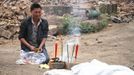 A man cries as he burns offering in front of the body of his relative after Saturday's earthquake, in Qingren township of Lushan county, Sichuan province April 21, 2013. Rescuers struggled to reach a remote, rural corner of southwestern China on Sunday as the toll of the dead and missing from the country's worst earthquake in three years climbed to 208 with almost 1,000 serious injuries. The 6.6 magnitude quake struck in Lushan county, near the city of Ya'an in the southwestern province of Sichuan, close to where a devastating 7.9 quake hit in May 2008, killing 70,000. Picture taken April 21, 2013. REUTERS/Stringer (CHINA - Tags: DISASTER SOCIETY) CHINA OUT. NO COMMERCIAL OR EDITORIAL SALES IN CHINA