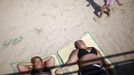 People lie on the beach at Coney Island in the Brooklyn borough of New York June 30, 2012. About 3.9 million homes and businesses were without power on Saturday amid a record heat wave in the eastern United States after deadly thunderstorms downed power lines from Indiana to New Jersey. REUTERS/Eric Thayer (UNITED STATES - Tags: ENVIRONMENT SOCIETY) Published: Čer. 30, 2012, 8:38 odp.