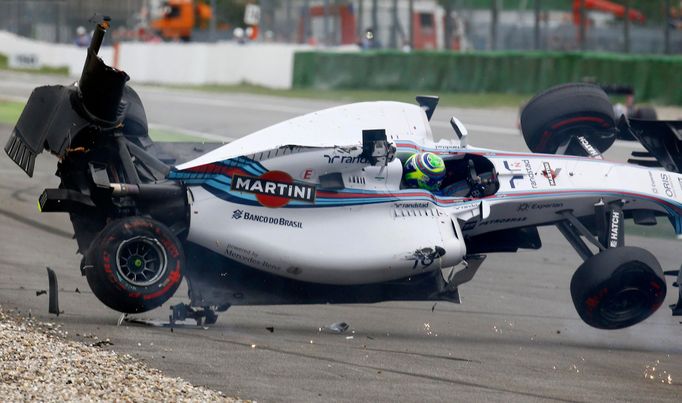 Williams Formula One driver Felipe Massa of Brazil crashes with his car in the first corner after the start of the German F1 Grand Prix at the Hockenheim racing circuit,