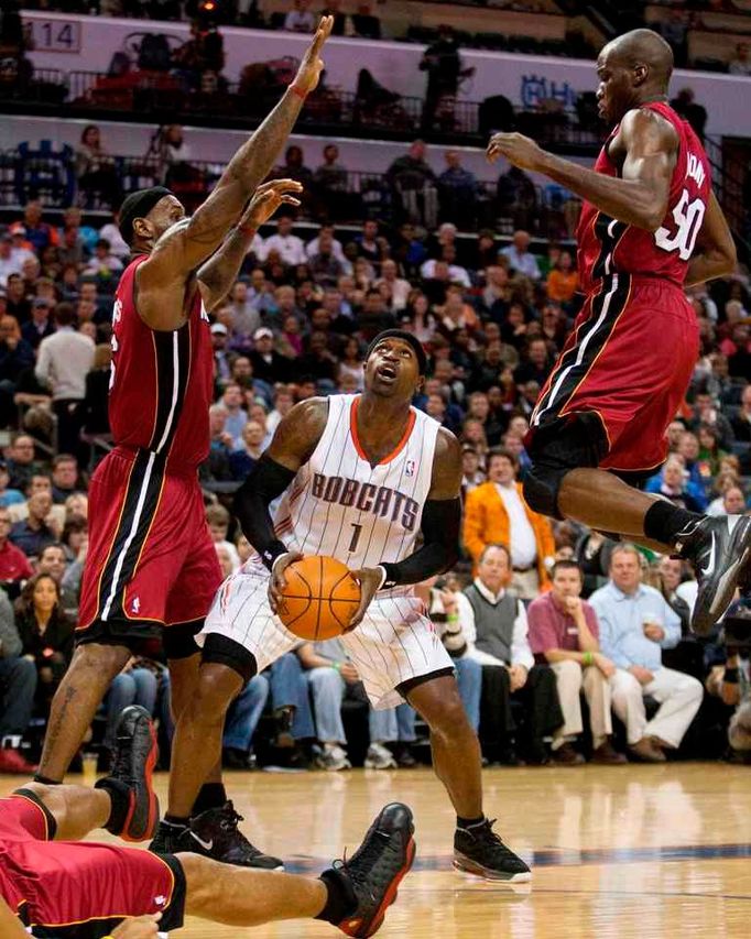 Stephen Jackson se nasuje ke střele přes LeBrona Jamese. Přihlíží Joel Anthony.