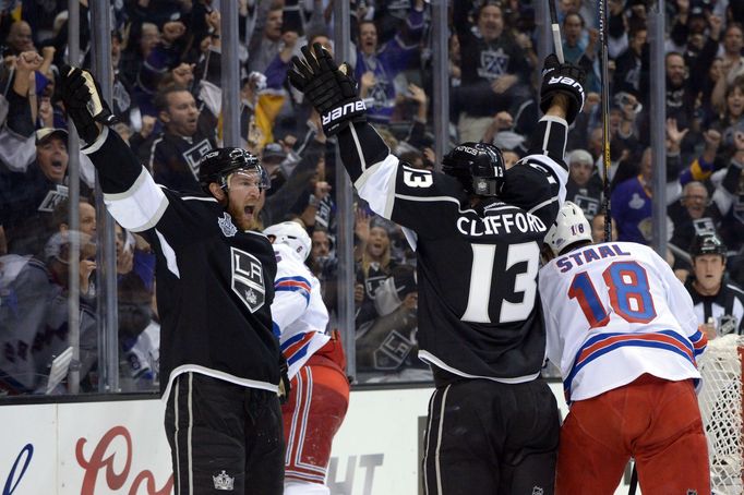 Jun 4, 2014; Los Angeles, CA, USA; Los Angeles Kings left wing Kyle Clifford (13) celebrates with center Jeff Carter (left) after scoring a goal against the New York Rang