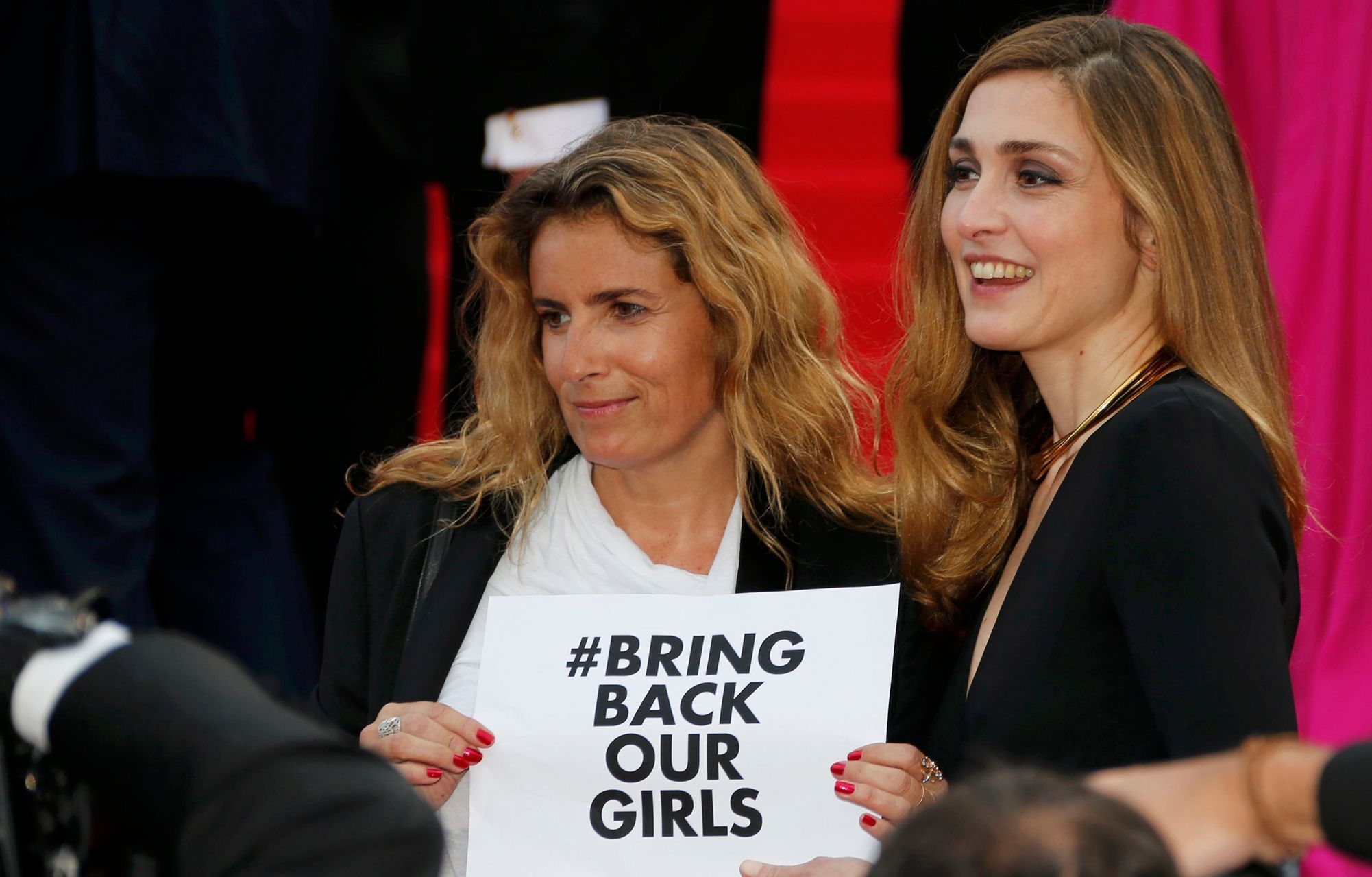 Actress Julie Gayet and director Lisa Azuelos hold a placard which reads &quot;Bring back our girls&quot; as they pose on the red carpet at the 67th Cannes Film Festival in Cannes