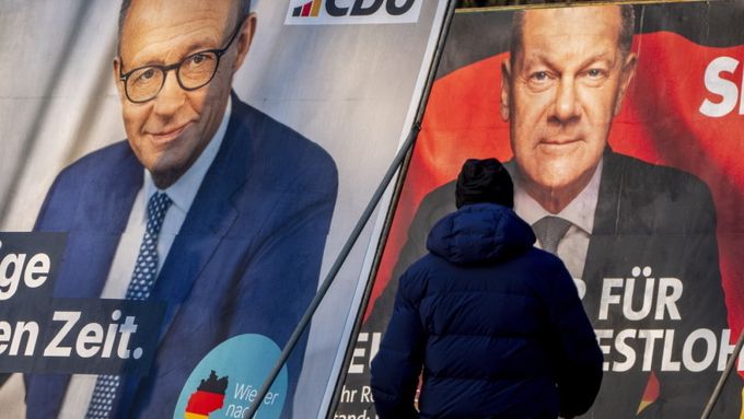 Muž prochází kolem volebních plakátů, na kterých je vyobrazen německý kancléř Olaf Scholz (vpravo) a hlavní kandidát CDU na kancléře Friedrich Merz, Frankfurt nad Mohanem, Německo, 8. února 2025