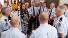 Catherine, the Duchess of Cambridge, talks with firefighters during a visit to the Blue Mountains suburb of Winmalee, that lost homes during bushfires last year, with her