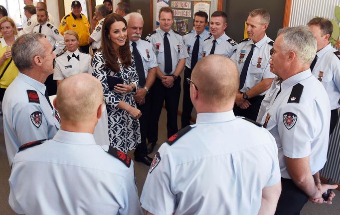 Catherine, the Duchess of Cambridge, talks with firefighters during a visit to the Blue Mountains suburb of Winmalee, that lost homes during bushfires last year, with her