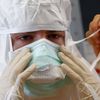 A volunteer has his mask adjusted during Red Cross Ebola training excercise in Wuerzburg