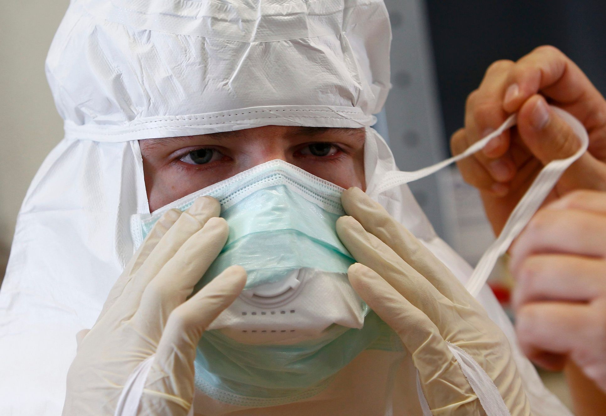 A volunteer has his mask adjusted during Red Cross Ebola training excercise in Wuerzburg