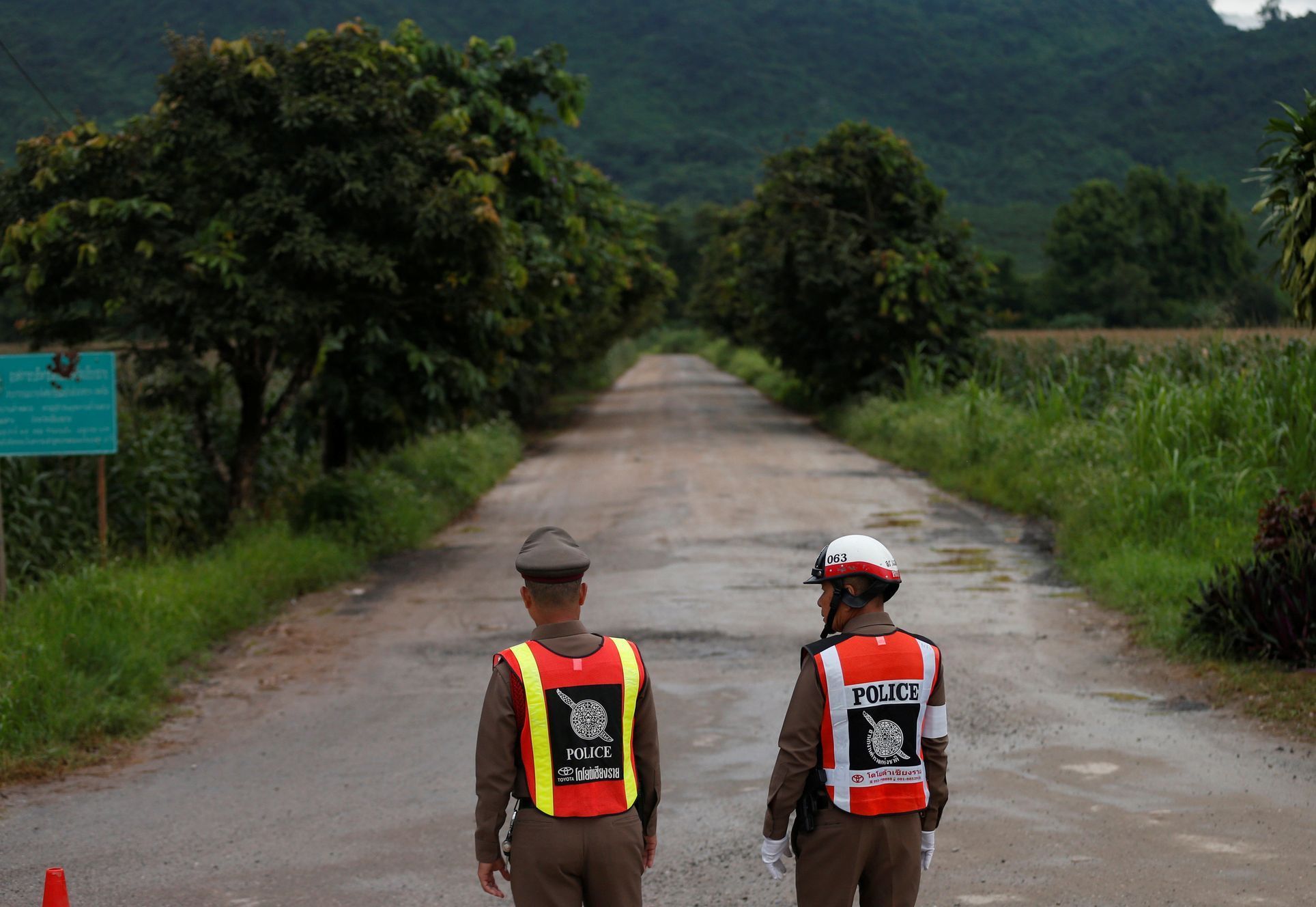 Police officers block a road leading to Tham Luang cave complex in the northern province of Chiang Rai