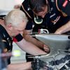 Mechanics work on part of Lotus Formula One driver Grosjean of France's car during the first practice session of the Australian F1 Grand Prix in Melbourne