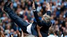 Manchester City's manager Manuel Pellegrini is thrown into the air by his team as they celebrate winning the English Premier League trophy following their soccer match ag