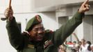 Sudanese President Omar Hassan al-Bashir waves to supporters after receiving victory greetings at the Defence Ministry, in Khartoum