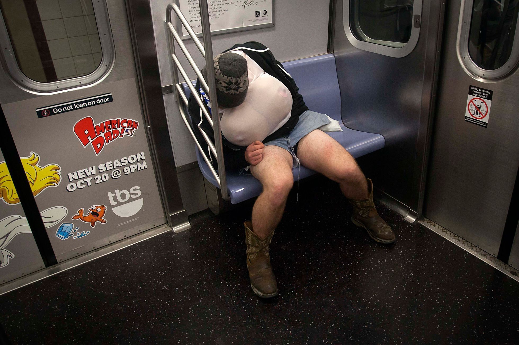 Halloween reveler sleeps on the uptown 6 subway train early in the morning in the Manhattan borough of New York