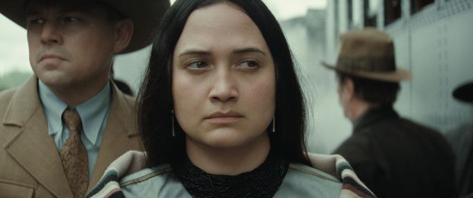 Leonardo DiCaprio jako Ernest a Lily Gladstone v roli Mollie.