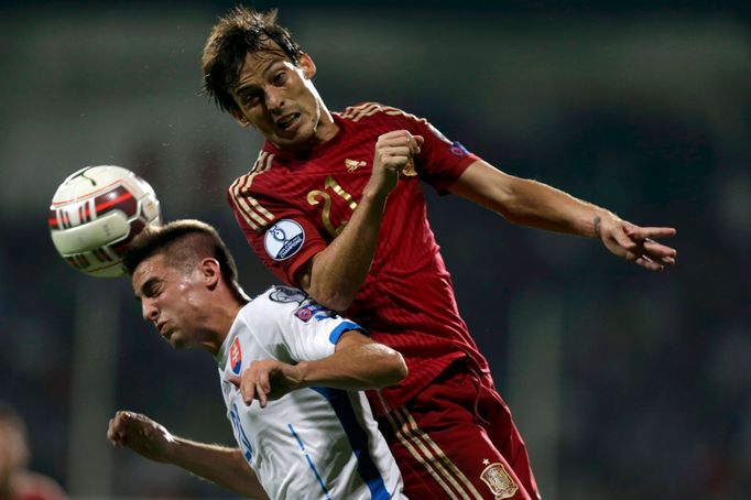 Silva of Spain challenges Mak of Slovakia during their Euro 2016 qualification soccer match at the MSK stadium in Zilina