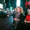 Halloween reveller Cara Chiarelli and her friends try to hail a taxi in Times Square early in the morning in the Manhattan borough of New York
