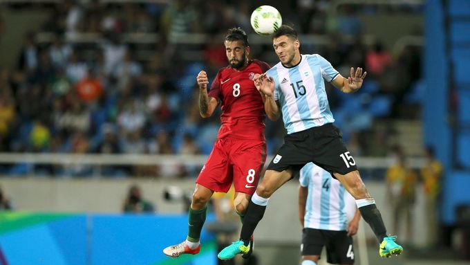 Sergio Oliveira (POR) of Portugal (L) and Lisandro Magallan (ARG) of Argentina (R) compete for the ball.