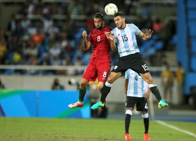 Sergio Oliveira (POR) of Portugal (L) and Lisandro Magallan (ARG) of Argentina (R) compete for the ball.