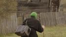 An elderly woman walks after purchasing products from a mobile shop on the eve of Radunitsa in the abandoned village of Tulgovichi