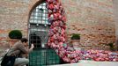 A visitor takes a picture of part of an installation called "The Garbage Patch State" by Italian artist Maria Cristina Finucci