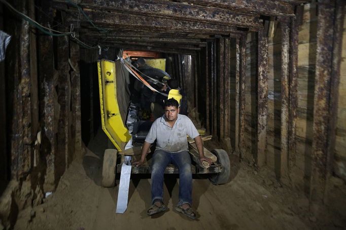 Palestinian workers drag parts of a car body by a four-wheels vehicle inside a huge tunnel for smuggling cars and spare parts beneath the border between Egypt and southern Gaza Strip in Rafah. by Wissam Nassar.